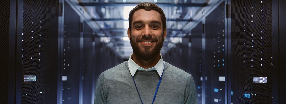 Smiling man standing in a server room